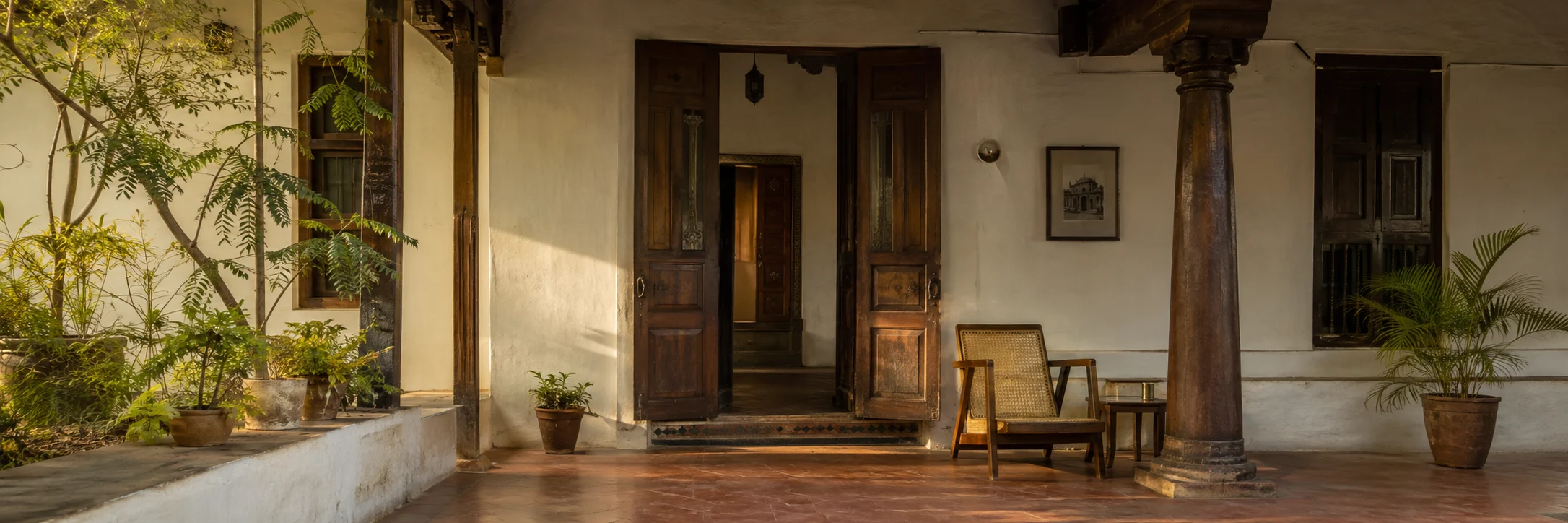 A Hyderabad verandah with lime plaster, aged teak, and red-oxide floors