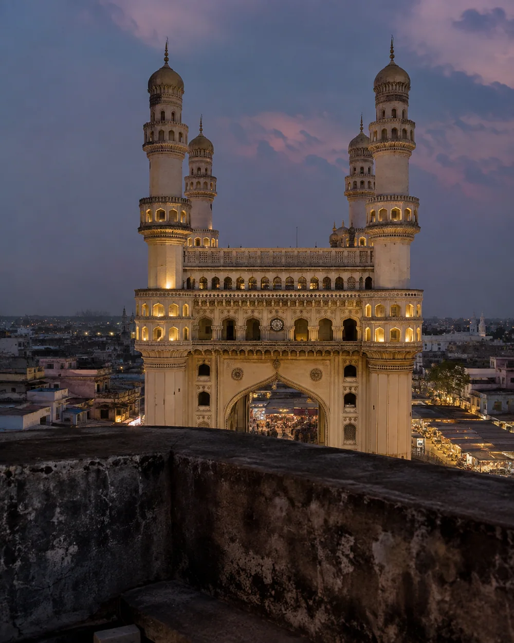 The Charminar rising above Hyderabad's old city at blue hour